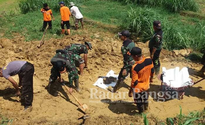 Para personil TNI-Polri, pemerintah kecamatan waru, BPBD Pamekasan dan masyarakat membersihkan material tanah akibat longsoran di dusun Kendal desa Waru Timur Kecamatan Waru Kabupaten Pamekasan

