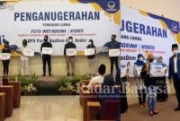 Ketua DPD Partai NasDem Kabupaten Kediri, Drs. H. Lutfi Mahmudiono menyerahkan hadiah Juara Lomba Lomba Foto Instagram dan Koreo