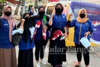 Para Srikandi DPD Partai NasDem Kabupaten Kediri sebelum membagikan bendera merah putih dan masker di perempatan Paron