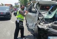 Petugas kepolisian bersama tim medis dibantu oleh pengguna jalan evakuasi korban kecelakaan di ruas jalan nasional Desa Plosowahyu Kecamatan Lamongan. Rabu (29/9/2021).