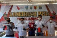 Kasat Reskrim Polres Lamongan AKP Yoan Septi Hendri, S.I.K., didampingi KBO Reskrim IPTU Suroto, Kanit 4 Kharis bersama Kasi Humas IPTU Jinanto saat menunjukkan barang bukti alat Pilox, celana warna hitam, pakaian yang digunakan pelaku Vandalisme. (Dok Foto: Istimewa / RadarBangsa.co.id).