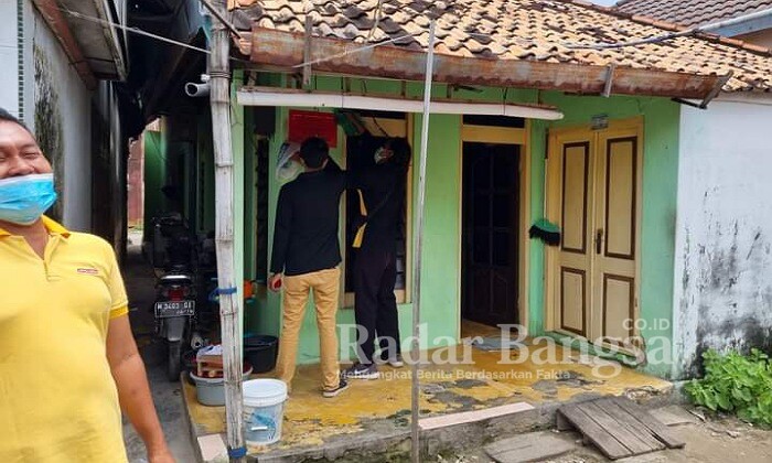 Petugas Dinsos Bangkalan saat menempeli rumah Kpn (IST)