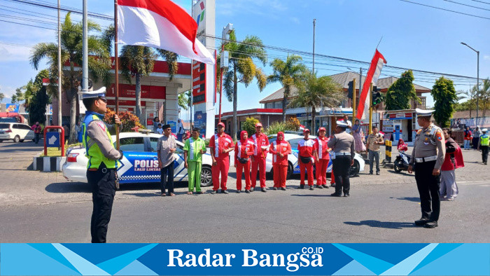 Peringatan detik-detik proklamasi tak hanya di gelar di lapangan, di Kabupaten Bondowoso peringatan hari kemerdekaan digelar di jalanan padat seluruh persimpangan dan jalan protokol.
Para pengendara roda 2 maupun roda 4 dihentikan sejenak oleh pihak kepolisian Satlantas Polres Bondowoso. Selanjutnya petugas pembawa bendera merah putih maju ke tengah jalan.