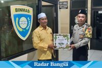 Kanit Binmas Polsek Tikung, Ipda Much Irawan saat memberikan bingkisan (IST)