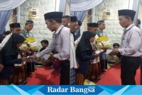 Penangunggjawab Kegiatan Zainul Arifin saat membagikan bantuan uang saku dari Ketua Umum Muslimat NU Khofifah Indar Parawansa  dan 50 paket beras kemasan 5 kg dari UD Tiga Saudara.(Dok foto panitia)