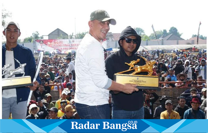 Pj Bupati Bangkalan, Dr. Arief M. Edie, M.Si., dengan simbolis penyerahan piala