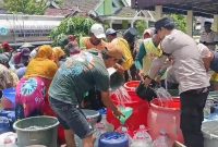 Anggota Polsek Tikung saat ikut membantu penyyaluran air bersih di desa soko