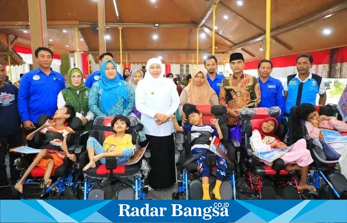 Gubernur Khofifah menyerahkan bantuan sosial kepada warga penerima manfaat di Pendopo Kabupaten Bangkalan (Dok Istimewa)