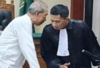 Ekspresi serius Wahyudi saat berdiskusi dengan tim kuasa hukum, di tengah jalannya sidang pemeriksaan saksi kasus proyek RPHU. (Foto Dok Ho/RadarBangsa)