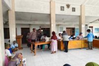 Bhabinkamtibmas Polsek Tikung bersama petugas desa dan Bulog saat memantau penyaluran bantuan beras cadangan pangan untuk KPM di Balai Desa Pengumbulanadi, Kecamatan Tikung, Lamongan, Jumat (25/7/2025). (Dok foto Ho/RadarBangsa)