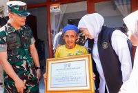 Khofifah menyerahkan kunci rumah layak huni kepada warga penerima bantuan bedah rumah di Jember. (Foto Dok Ho/RadarBangsa.co.id)