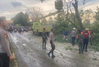 Personel Polres Lamongan bersama Polsek Sukodadi mengevakuasi pohon tumbang yang menutup jalur utama Kecamatan Sukodadi, Lamongan, Senin (20/10/2025) (Foto Dok Ho/RadarBangsa.co.id)