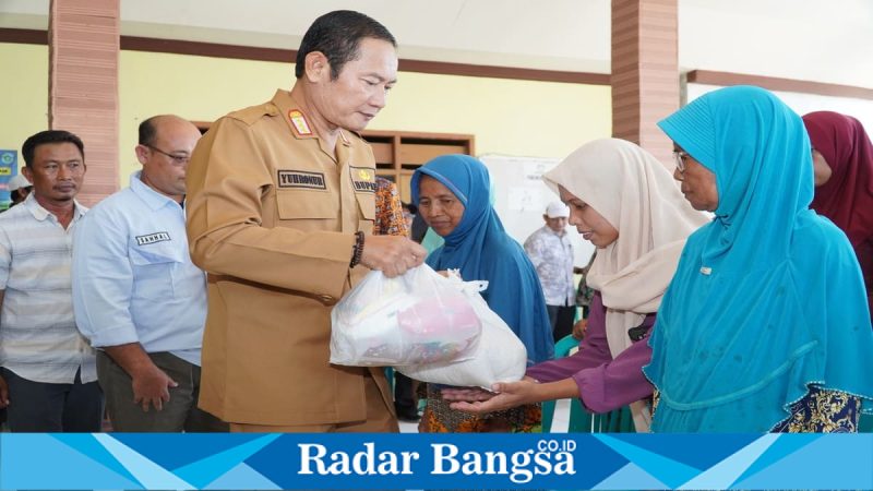 Bupati Lamongan Yuhronur Efendi menyerahkan bantuan beras dan sembako kepada warga terdampak banjir di Desa Ngujungrejo, Kecamatan Turi, Kamis (12/3/2026). (Foto Dok Ho/RadarBangsa.co.id)