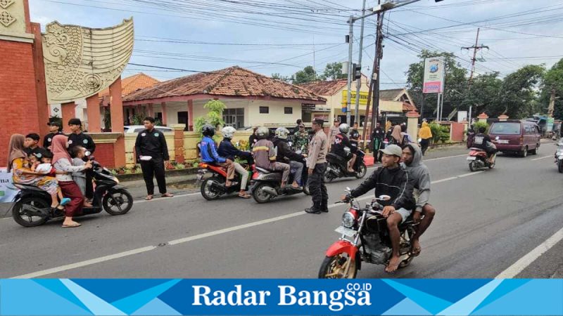 Anggota Pagar Nusa Tikung membagikan takjil kepada pengguna jalan di depan Kantor Kecamatan Tikung, Minggu (8/3/2026). (Foto Dok Ho/RadarBangsa.co.id)