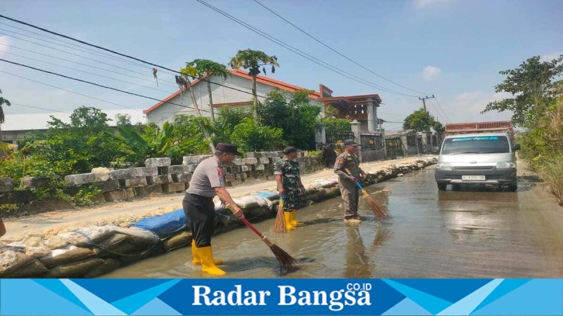 Petugas gabungan membersihkan lumut di jalan Dusun Glumo, Senin (6/4/2026). (Foto Dok Ho/RadarBangsa.co.id)