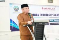 Wakil Bupati Bangkalan Moh. Fauzan Ja'far membuka Pertemuan Evaluasi Pelaksanaan dan Capaian Program Pemeriksaan Kesehatan Gratis (PKG) di Aula Hotel Roos, Bangkalan, Selasa (14/7/2026). (Foto Dok Ho/RadarBangsa.co.id)