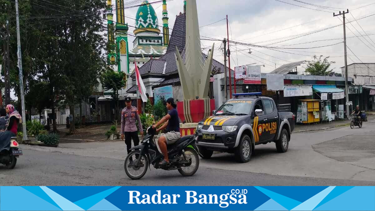 Petugas Polsek Laren melakukan pengaturan lalu lintas pagi di Pasar Laren, Lamongan, Jumat (16/7/2026), untuk menjaga kelancaran arus kendaraan. (Foto Dok Ho/RadarBangsa.co.id)