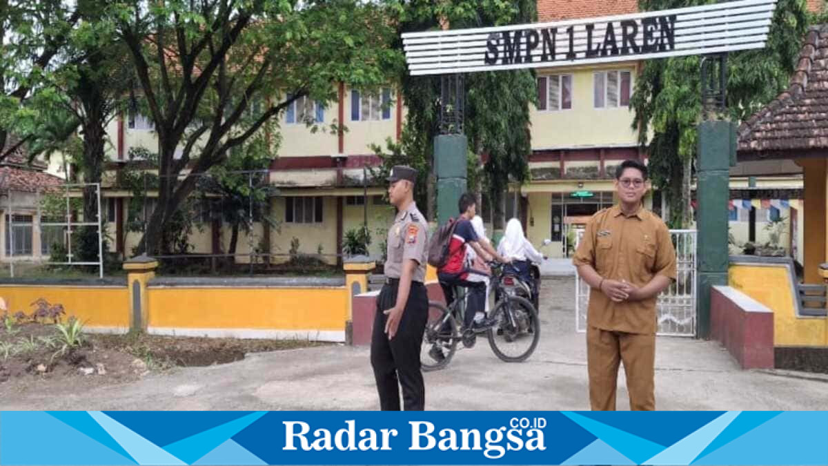 Personel Polsek Laren mengatur arus lalu lintas di depan SMP Negeri 1 Laren, Lamongan, Jumat (17/7/2026). (Foto Dok Ho/RadarBangsa.co.id)