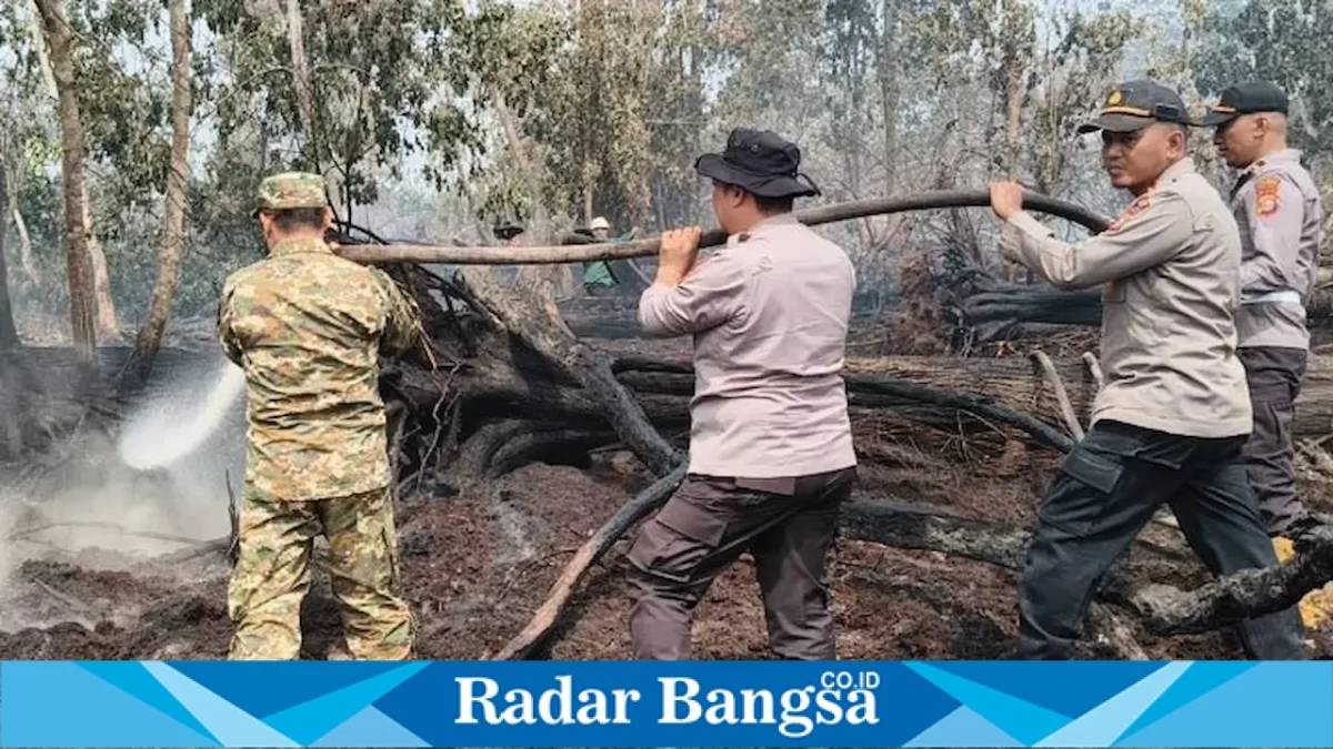 Kapolres Pelalawan AKBP John Louis Letedara bersama Wakil Bupati Pelalawan Husni Thamrin saat memadamkan karhutla di Tanjung Kosik, Desa Teluk Binjai, Kamis (13/8/2026). (Foto Dok Ho/RadarBangsa.co.id)